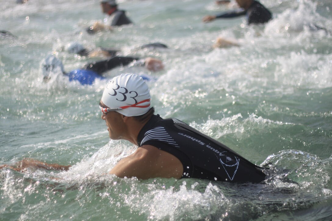 A competitor starts the one-kilometer swim at the marina during the Japanese and American Goodwill Modified Triathlon aboard Marine Corps Air Station Iwakuni, Japan, Sept. 22, 2013. According to Mai Tajima, SemperFit recreation specialist, this year marks the highest number of participants in the triathlon.