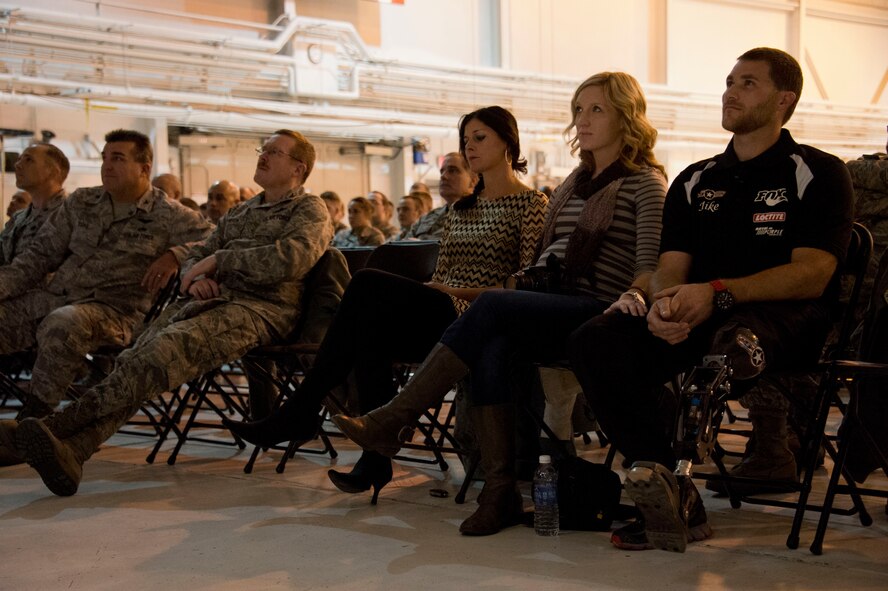 Airmen from the 133rd Airlift Wing gather in the north hangar for the Wingman Day guest speaker in St. Paul, Minn., Oct. 26, 2013.  Mike Schultz a professional snocross rider, owner, and engineer for Bioadapt Inc. speaks to the Airmen about resiliency after life changing events. 
(U.S. Air National Guard Photo by Senior Airman Kari Giles/released.)
