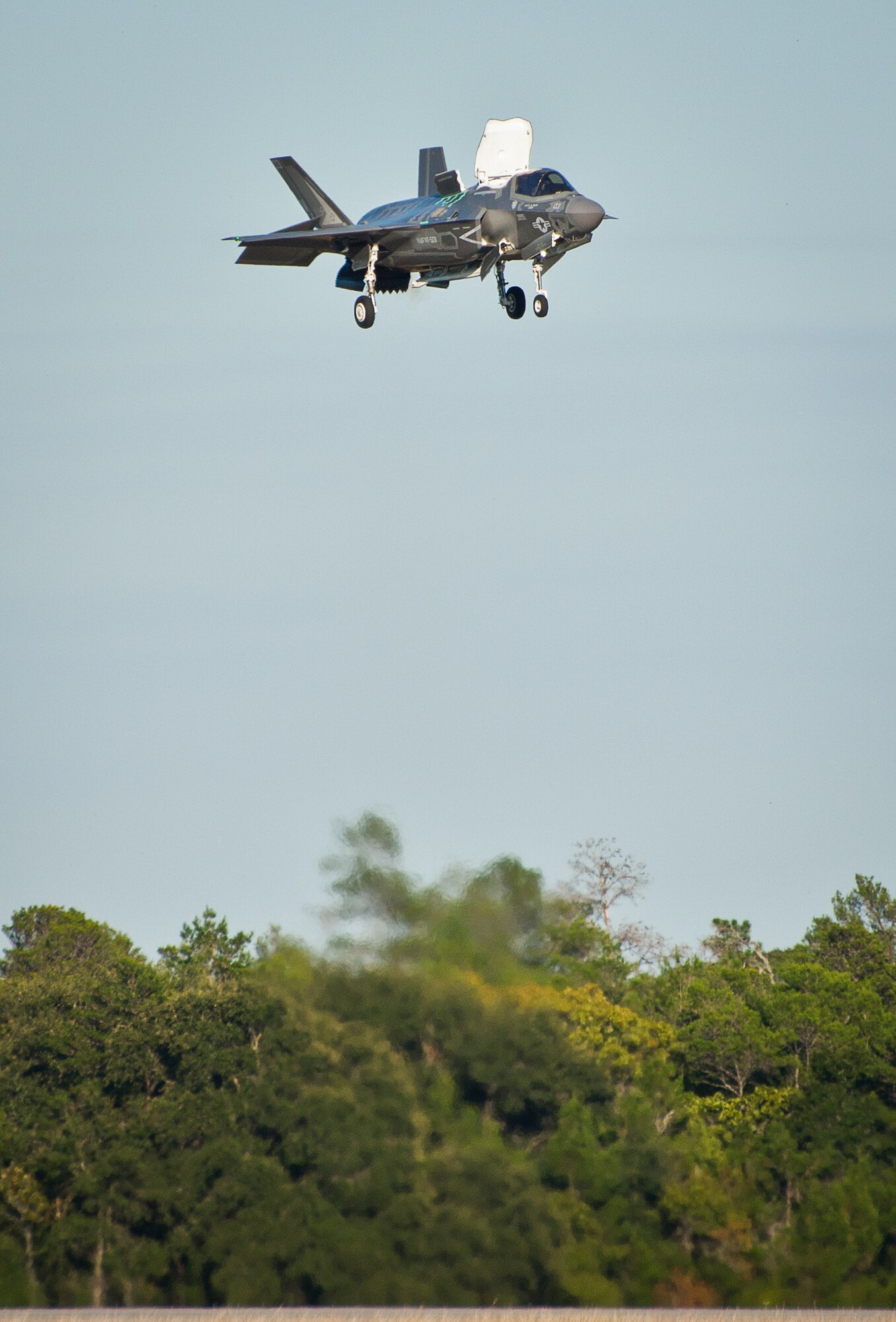A Marine F-35B joint strike fighter hovers over the runway during the first short take-off and vertical landing mission at Eglin Air Force Base, Fla., Oct. 25. The milestone training mission was flown by Maj. Brendan M. Walsh, of the Marine Fighter Attack Training Squadron-501.  Walsh recently qualified in vertical landing operations at Marine Corps Air Station Yuma, Ariz. in preparation for this mission.  (U.S. Air Force photo/Samuel King Jr.)