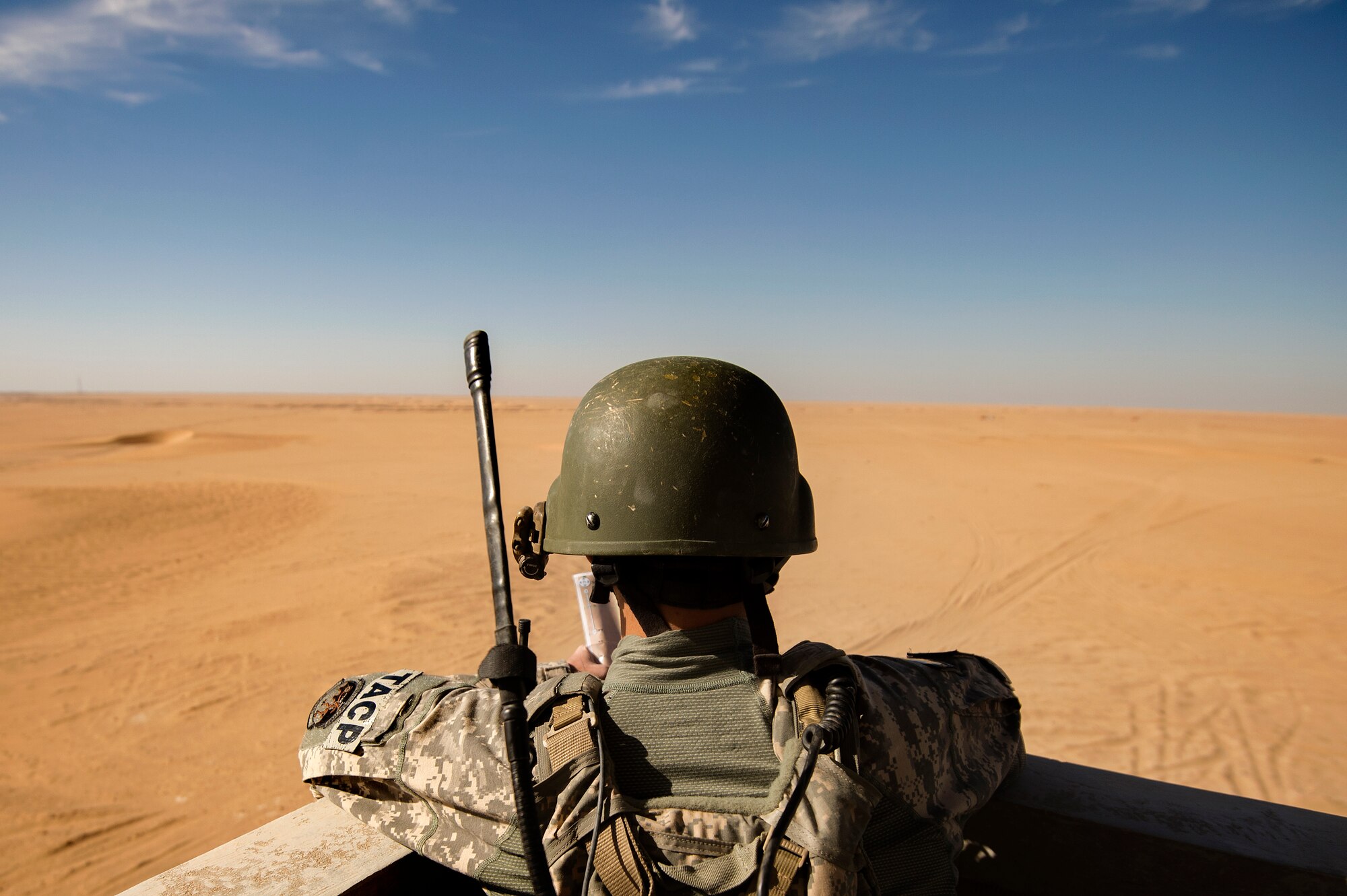 Senior Airman Justin Tamayo, 82nd Expeditionary Air Support Operations Squadron Tactical Air Control Party airman, monitors incoming combat aircraft during a joint live-fire exercise Oct. 23, 2013, at a regional range in Southwest Asia. The 82nd EASOS provides air-to-ground joint terminal attack controllers and weather expertise to the U.S. Army Central Task Force. Tanayo, hailing from Keaau, Hawaii, is deployed from Fort Carson, Colo. (U.S. Air Force Photo/Master Sgt. Ben Bloker)