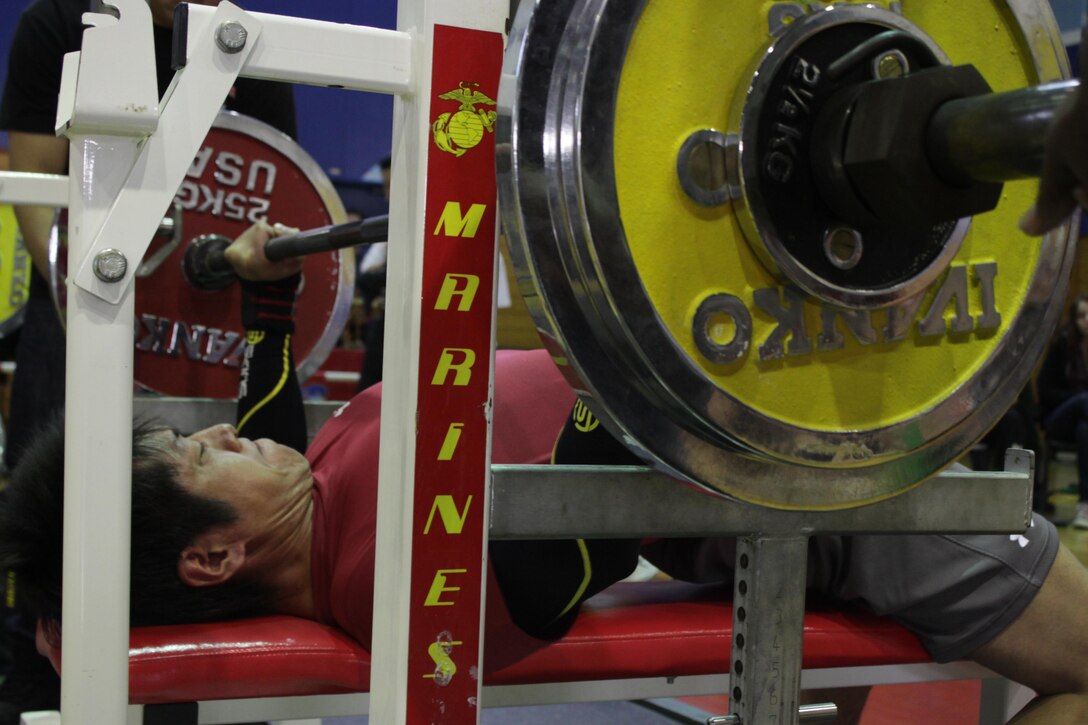 Makoto Kawate performs a bench press during the Open Bench Press Competition, which took place inside the IronWorks Gym Sports Court here, Jan 19, 2013. Athletes competed in their specific weight classes and were judged by how much total weight they were able to lift in three attempts.