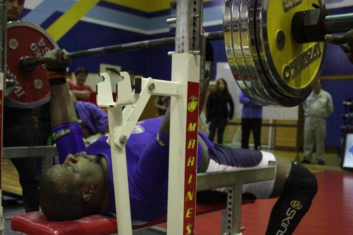 Willie Dearinge, Open Bench Press Competition athlete, performs a bench press during the competition, which took place inside the IronWorks Gym Sports Court here, Jan 19, 2013. Athletes competed in their specific weight classes and were judged by how much total weight they were able to lift in three attempts.