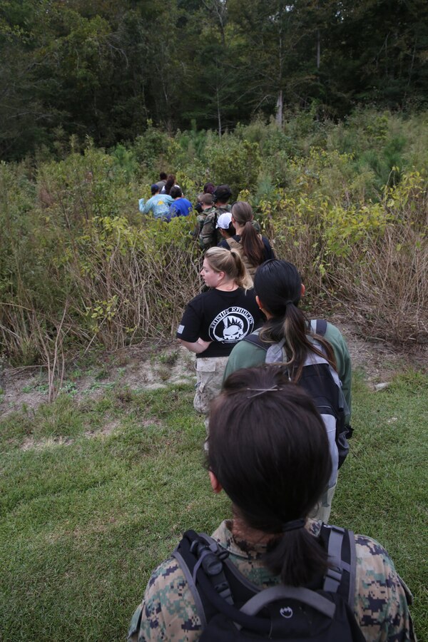 Marine Special Operations Regiment hosted a Jane Wayne Day event, Oct. 19, 2013, on Camp Lejeune, N.C.  Wives of U.S. Marine Corps Forces, Special Operations Command personnel participated in the event, experiencing firsthand how Marines with MARSOC train for missions. This Jane Wayne Day event immersed participants in an interactive scenario comprising patrols, a run through an obstacle course, rides on zodiac boats, encounters with role-players and a simulated raid on a town.  MARSOC Marines supervised the entire event, and assisted the family members throughout the scenario.(U.S. Marine Corps Photo by Lance Cpl. Steven Fox/Released)