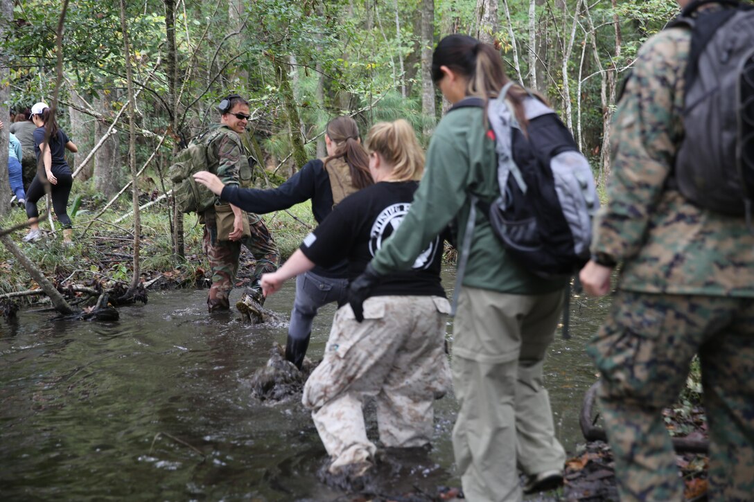 Marine Special Operations Regiment hosted a Jane Wayne Day event, Oct. 19, 2013, on Camp Lejeune, N.C.  Wives of U.S. Marine Corps Forces, Special Operations Command personnel participated in the event, experiencing firsthand how Marines with MARSOC train for missions. This Jane Wayne Day event immersed participants in an interactive scenario comprising patrols, a run through an obstacle course, rides on zodiac boats, encounters with role-players and a simulated raid on a town.  MARSOC Marines supervised the entire event, and assisted the family members throughout the scenario. (U.S. Marine Corps Photo by Lance Cpl. Steven Fox/Released)