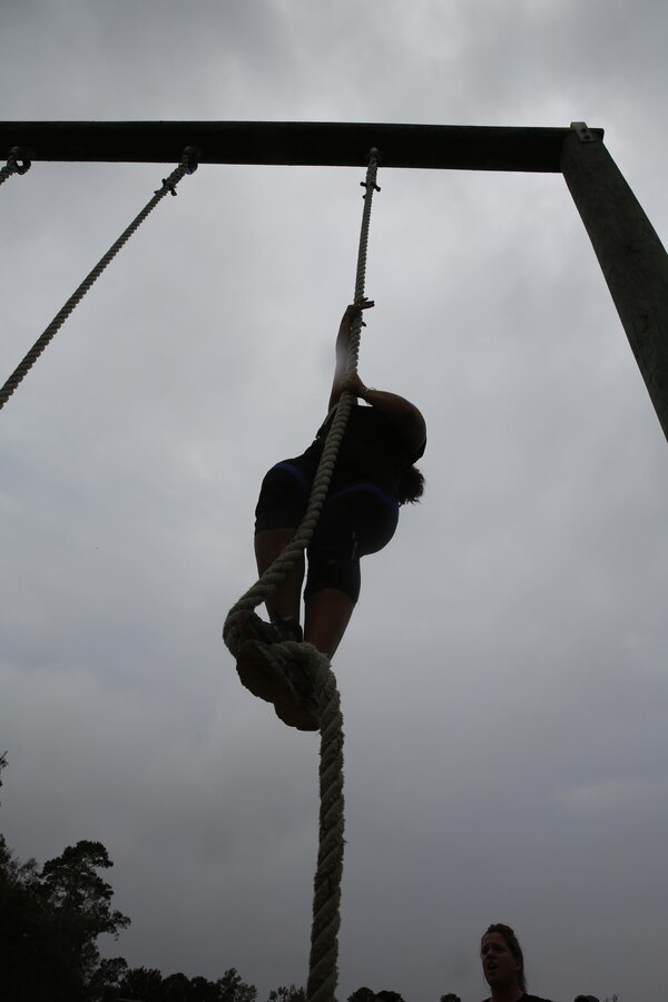 Participants of a Jane Wayne Day event run through an obstacle course on Camp Lejeune, N.C., Oct. 19, 2013.  The event was organized by Marine Special Operations Regiment, allowing wives of MARSOC personnel to experience firsthand how Critical Skills Operators train for missions.  This Jane Wayne Day event immersed participants in an interactive scenario comprising patrols, a run through an obstacle course, rides on zodiac boats, encounters with role-players and a simulated raid on a town.  MARSOC Marines supervised the entire event, and assisted the family members throughout the scenario. (U.S. Marine Corps Photo by Lance Cpl. Steven Fox/Released)
