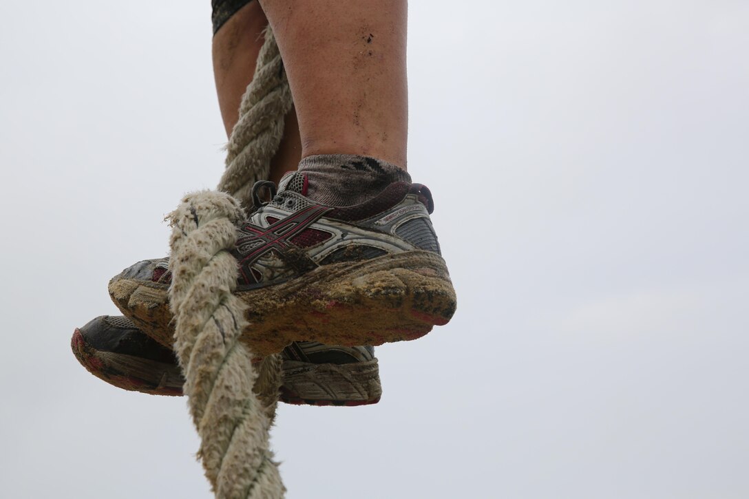 Participants of a Jane Wayne Day event run through an obstacle course on Camp Lejeune, N.C., Oct. 19, 2013.  The event was organized by Marine Special Operations Regiment, allowing wives of MARSOC personnel to experience firsthand how Critical Skills Operators train for missions.  This Jane Wayne Day event immersed participants in an interactive scenario comprising patrols, a run through an obstacle course, rides on zodiac boats, encounters with role-players and a simulated raid on a town.  MARSOC Marines supervised the entire event, and assisted the family members throughout the scenario. (U.S. Marine Corps Photo by Lance Cpl. Steven Fox/Released)