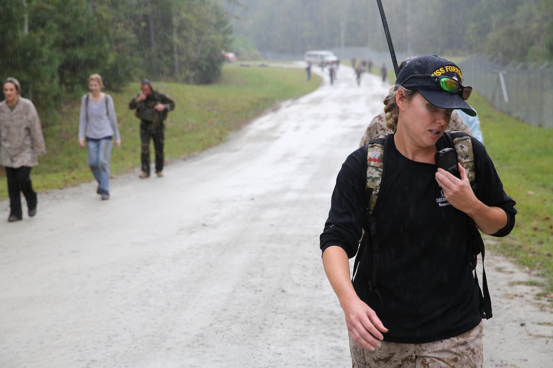 Participants of a Jane Wayne Day event patrol in a tactical formation on Camp Lejeune, N.C., Oct. 19, 2013.  The event was organized by Marine Special Operations Regiment, allowing wives of MARSOC personnel to experience firsthand how Critical Skills Operators train for missions.  This Jane Wayne Day event immersed participants in an interactive scenario comprising patrols, a run through an obstacle course, rides on zodiac boats, encounters with role-players and a simulated raid on a town.  MARSOC Marines supervised the entire event, and assisted the family members throughout the scenario. (U.S. Marine Corps Photo by Lance Cpl. Steven Fox/Released)