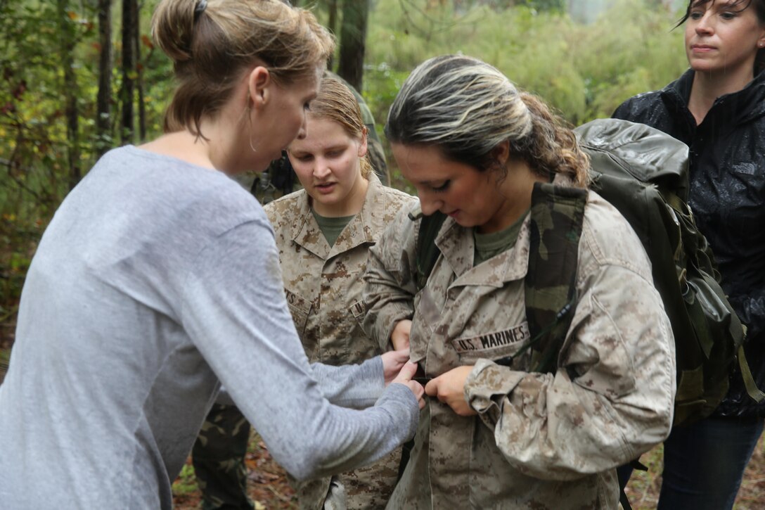 Participants of a Jane Wayne Day event patrol in a tactical formation on Camp Lejeune, N.C., Oct. 19, 2013.  The event was organized by Marine Special Operations Regiment, allowing wives of MARSOC personnel to experience firsthand how Critical Skills Operators train for missions.  This Jane Wayne Day event immersed participants in an interactive scenario comprising patrols, a run through an obstacle course, rides on zodiac boats, encounters with role-players and a simulated raid on a town. MARSOC Marines supervised the entire event, and assisted the family members throughout the scenario.(U.S. Marine Corps Photo by Lance Cpl. Steven Fox/Released)