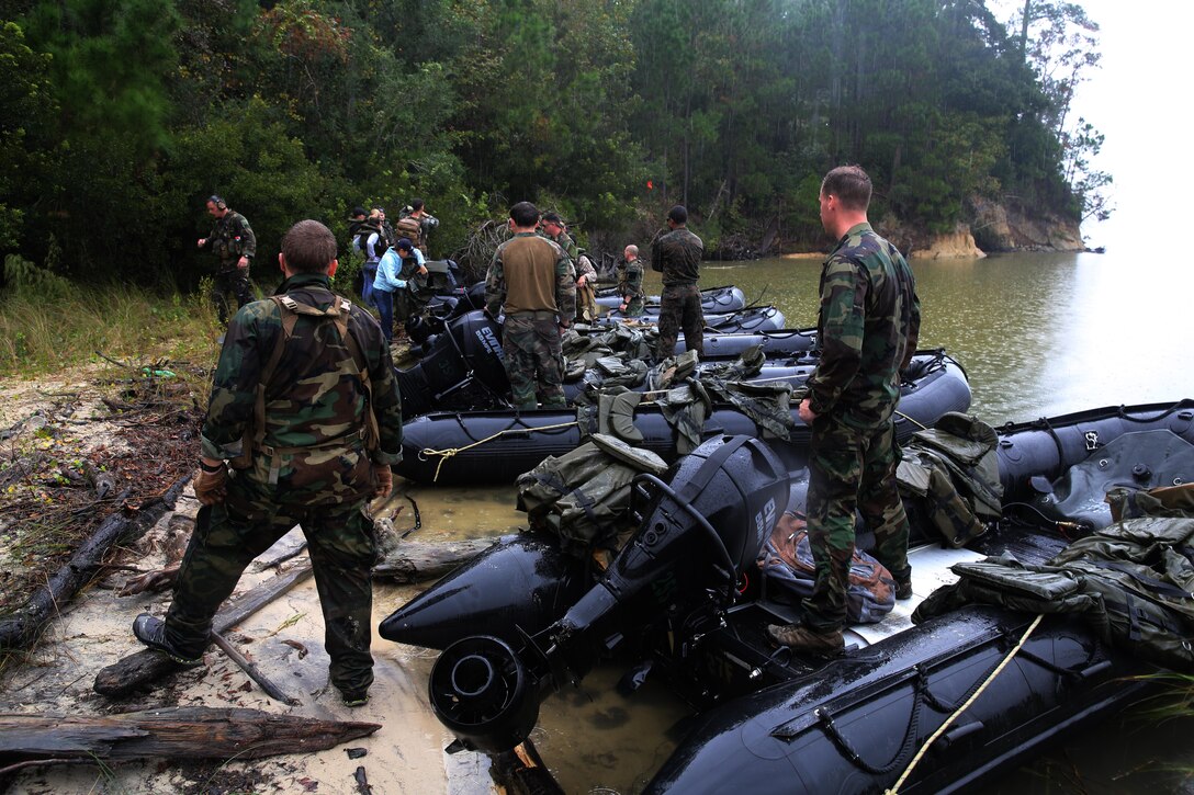 Marines with U.S. Marine Corps Forces, Special Operations Command prepare to transport participants of a Jane Wayne Day event to a location on Camp Lejeune, N.C., via zodiac boats, Oct. 19, 2013.  The event was organized by Marine Special Operations Regiment, allowing wives of MARSOC personnel to experience firsthand how Critical Skills Operators train for missions.  This Jane Wayne Day event immersed participants in an interactive scenario comprising patrols, a run through an obstacle course, rides on zodiac boats, encounters with role-players and a simulated raid on a town.  MARSOC Marines supervised the entire event, and assisted the family members throughout the scenario. (U.S. Marine Corps Photo by Lance Cpl. Steven Fox/Released)