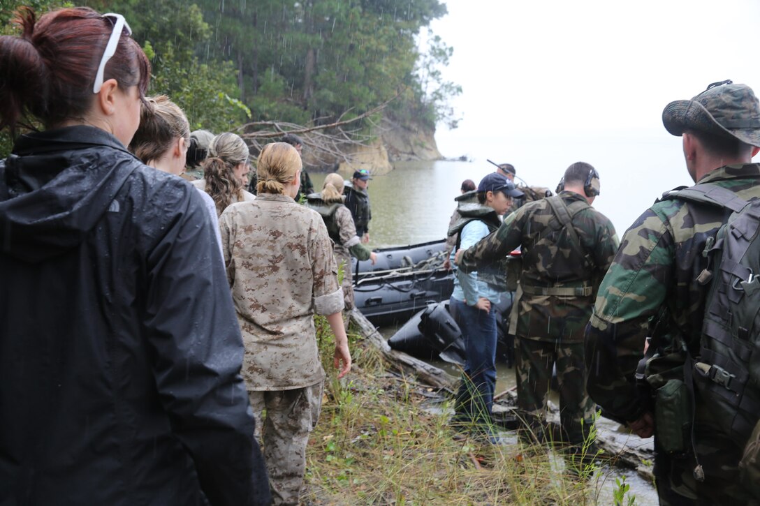 Marines with U.S. Marine Corps Forces, Special Operations Command prepare to transport participants of a Jane Wayne Day event to a location on Camp Lejeune, N.C., via zodiac boats, Oct. 19, 2013.  The event was organized by Marine Special Operations Regiment, allowing wives of MARSOC personnel to experience firsthand how Critical Skills Operators train for missions.  This Jane Wayne Day event immersed participants in an interactive scenario comprising patrols, a run through an obstacle course, rides on zodiac boats, encounters with role-players and a simulated raid on a town.  MARSOC Marines supervised the entire event, and assisted the family members throughout the scenario. (U.S. Marine Corps Photo by Lance Cpl. Steven Fox/Released)