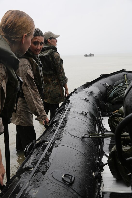 Marines with U.S. Marine Corps Forces, Special Operations Command prepare to transport participants of a Jane Wayne Day event to a location on Camp Lejeune, N.C., via zodiac boats, Oct. 19, 2013.  The event was organized by Marine Special Operations Regiment, allowing wives of MARSOC personnel to experience firsthand how Critical Skills Operators train for missions.  This Jane Wayne Day event immersed participants in an interactive scenario comprising patrols, a run through an obstacle course, rides on zodiac boats, encounters with role-players and a simulated raid on a town.  MARSOC Marines supervised the entire event, and assisted the family members throughout the scenario. (U.S. Marine Corps Photo by Lance Cpl. Steven Fox/Released)