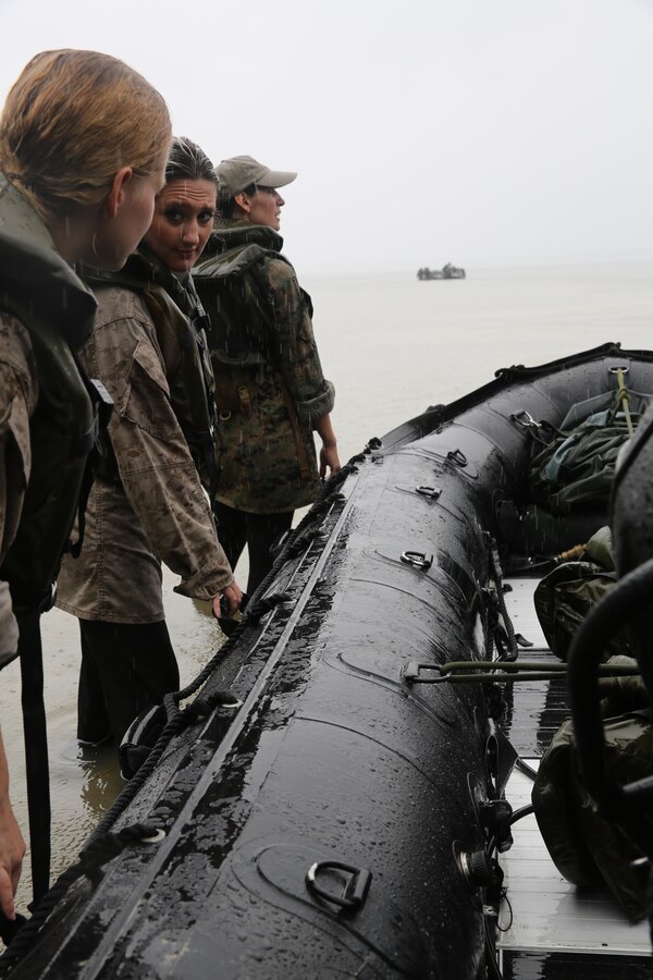 Marines with U.S. Marine Corps Forces, Special Operations Command prepare to transport participants of a Jane Wayne Day event to a location on Camp Lejeune, N.C., via zodiac boats, Oct. 19, 2013.  The event was organized by Marine Special Operations Regiment, allowing wives of MARSOC personnel to experience firsthand how Critical Skills Operators train for missions.  This Jane Wayne Day event immersed participants in an interactive scenario comprising patrols, a run through an obstacle course, rides on zodiac boats, encounters with role-players and a simulated raid on a town.  MARSOC Marines supervised the entire event, and assisted the family members throughout the scenario. (U.S. Marine Corps Photo by Lance Cpl. Steven Fox/Released)