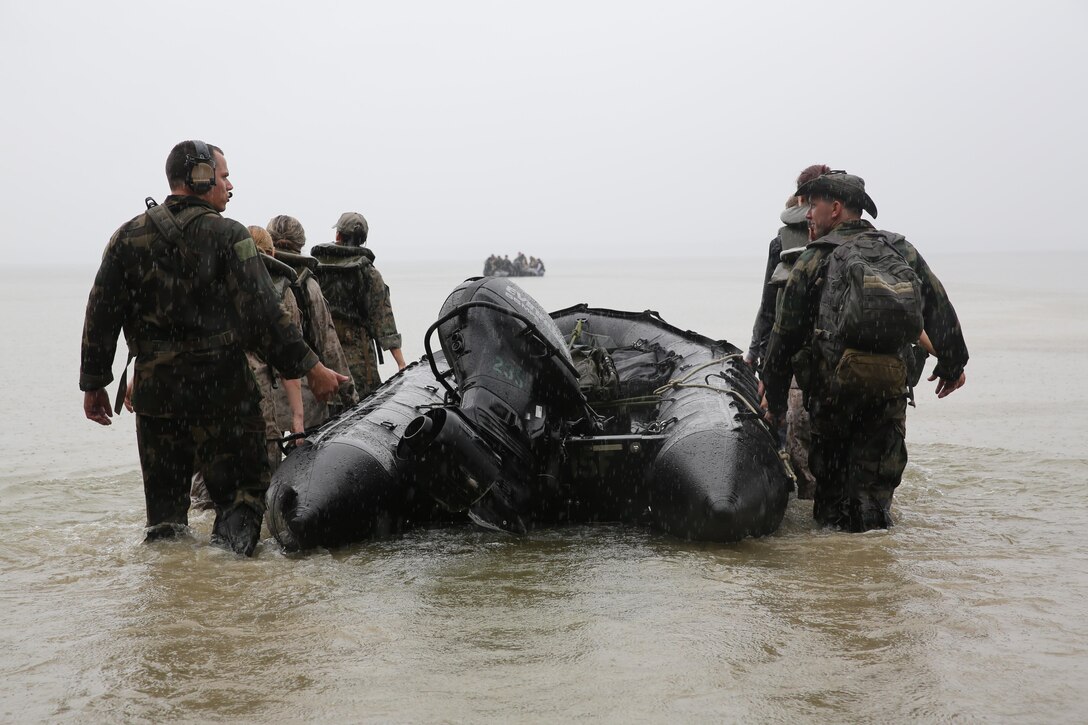 Marines with U.S. Marine Corps Forces, Special Operations Command prepare to transport participants of a Jane Wayne Day event to a location on Camp Lejeune, N.C., via zodiac boats, Oct. 19, 2013.  The event was organized by Marine Special Operations Regiment, allowing wives of MARSOC personnel to experience firsthand how Critical Skills Operators train for missions.  This Jane Wayne Day event immersed participants in an interactive scenario comprising patrols, a run through an obstacle course, rides on zodiac boats, encounters with role-players and a simulated raid on a town.  MARSOC Marines supervised the entire event, and assisted the family members throughout the scenario. (U.S. Marine Corps Photo by Lance Cpl. Steven Fox/Released)