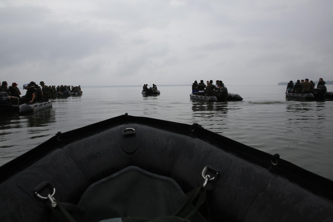 Marines with U.S. Marine Corps Forces, Special Operations Command prepare to transport participants of a Jane Wayne Day event to a location on Camp Lejeune, N.C., via zodiac boats, Oct. 19, 2013.  The event was organized by Marine Special Operations Regiment, allowing wives of MARSOC personnel to experience firsthand how Critical Skills Operators train for missions.  This Jane Wayne Day event immersed participants in an interactive scenario comprising patrols, a run through an obstacle course, rides on zodiac boats, encounters with role-players and a simulated raid on a town.  MARSOC Marines supervised the entire event, and assisted the family members throughout the scenario. (U.S. Marine Corps Photo by Lance Cpl. Steven Fox/Released)