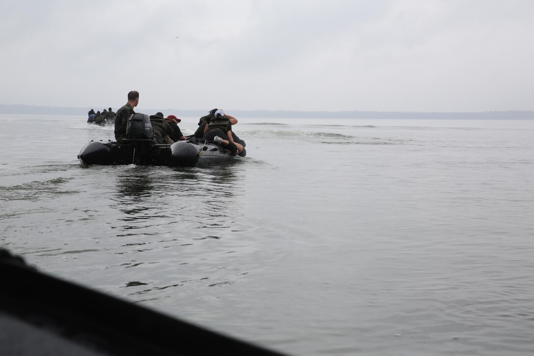 Marines with U.S. Marine Corps Forces, Special Operations Command prepare to transport participants of a Jane Wayne Day event to a location on Camp Lejeune, N.C., via zodiac boats, Oct. 19, 2013.  The event was organized by Marine Special Operations Regiment, allowing wives of MARSOC personnel to experience firsthand how Critical Skills Operators train for missions.  This Jane Wayne Day event immersed participants in an interactive scenario comprising patrols, a run through an obstacle course, rides on zodiac boats, encounters with role-players and a simulated raid on a town.  MARSOC Marines supervised the entire event, and assisted the family members throughout the scenario. (U.S. Marine Corps Photo by Lance Cpl. Steven Fox/Released)