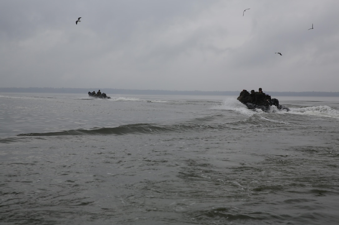 Participants of a Jane Wayne Day event hang on tight as they are transported to a location on Camp Lejeune, N.C., via zodiac boats, Oct. 19, 2013.  The event was organized by Marine Special Operations Regiment, allowing wives of MARSOC personnel to experience firsthand how Critical Skills Operators train for missions.  This Jane Wayne Day event immersed participants in an interactive scenario comprising patrols, a run through an obstacle course, rides on zodiac boats, encounters with role-players and a simulated raid on a town.  MARSOC Marines supervised the entire event, and assisted the family members throughout the scenario. (U.S. Marine Corps Photo by Lance Cpl. Steven Fox/Released)