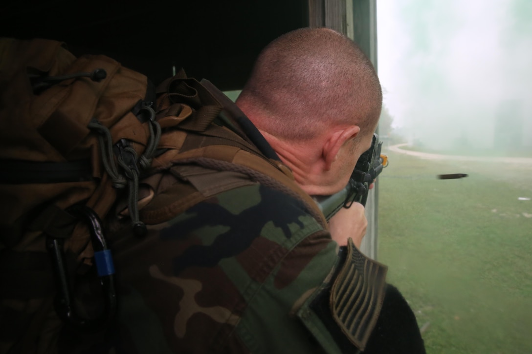 Participants of a Jane Wayne Day event raid a town during the last portion of a simulated special operations mission on Camp Lejeune, N.C., Oct. 19, 2013.  The event was organized by Marine Special Operations Regiment, allowing wives of MARSOC personnel to experience firsthand how Critical Skills Operators train for missions.  This Jane Wayne Day event immersed participants in an interactive scenario comprising patrols, a run through an obstacle course, rides on zodiac boats, encounters with role-players and a simulated raid on a town.  MARSOC Marines supervised the entire event, and assisted the family members throughout the scenario. (U.S. Marine Corps Photo by Lance Cpl. Steven Fox/Released)