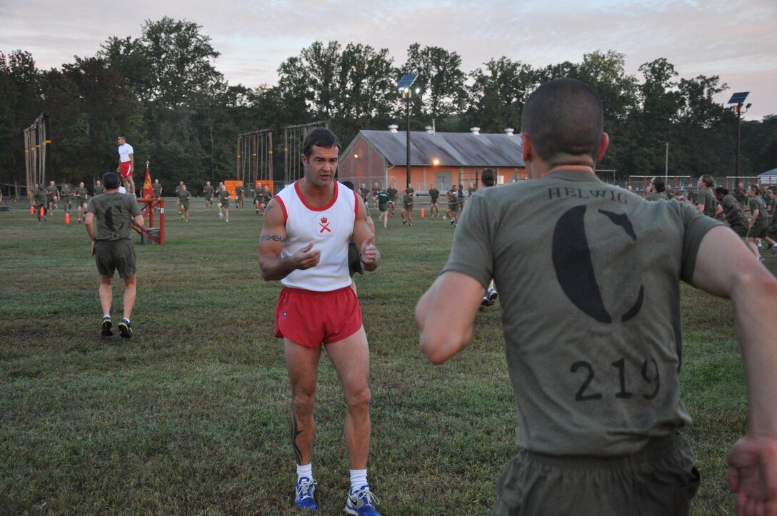 Colour Sergeant Glyn Luke, a British Royal Marine and physical training advisor to the Commanding Officer at Officer Candidates School, observes and coaches candidates during a morning physical training session Sept. 30, 2013.
