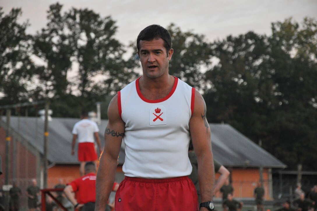 Colour Sergeant Glyn Luke, a British Royal Marine and physical training advisor to the Commanding Officer at Officer Candidates School, observes and coaches candidates during a morning physical training session Sept. 30, 2013.