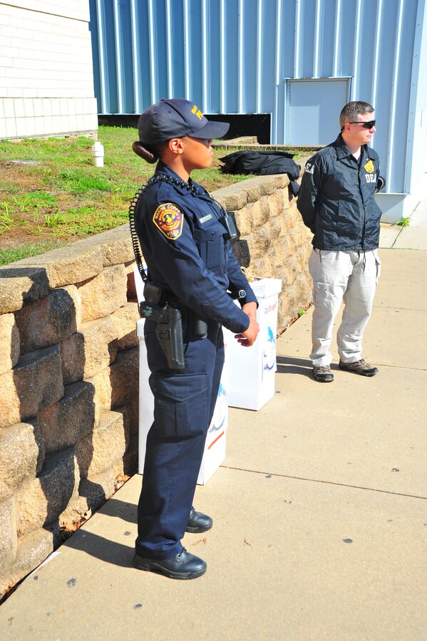 Brandi Salvant, officer, Provost Marshal Office, and Drug Enforcement Administration Agent Michael A. Beyer, stand at their drug drop-off point at the Marine Corps Exchange as part of the “National Drug Take Back Initiative”  hosted by Security Battalion on Oct. 23, 2013. This is the fourth year in a row Security Battalion has hosted the event. 
