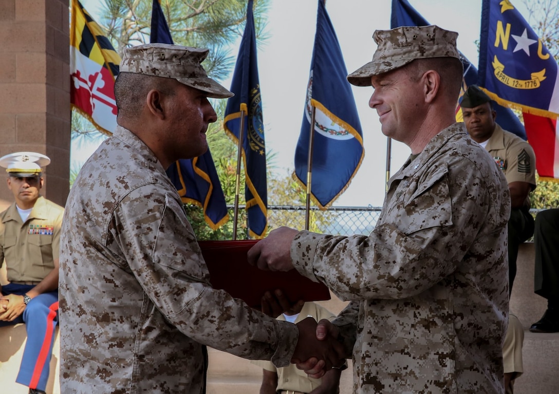 Lieutenant Col. John O'Neal, left, commanding officer, 15th Marine Expeditionary Unit, presents Staff Sgt. Mario Rodriguez, warehouse chief, with various letters of appreciation and his certificate of retirement during his retirement ceremony aboard Camp Pendleton, Calif., Oct. 25. Rodriguez, 39, served 20 years and is a native of Plainview, Texas. The letters of appreciation were from President Barack Obama, Gen. James F. Amos, commandant of the Marine Corps, and Sgt. Maj. Micheal P. Barrett, sergeant major of the Marine Corps. (U.S. Marine Corps Photo by Cpl. Emmanuel Ramos/Released)