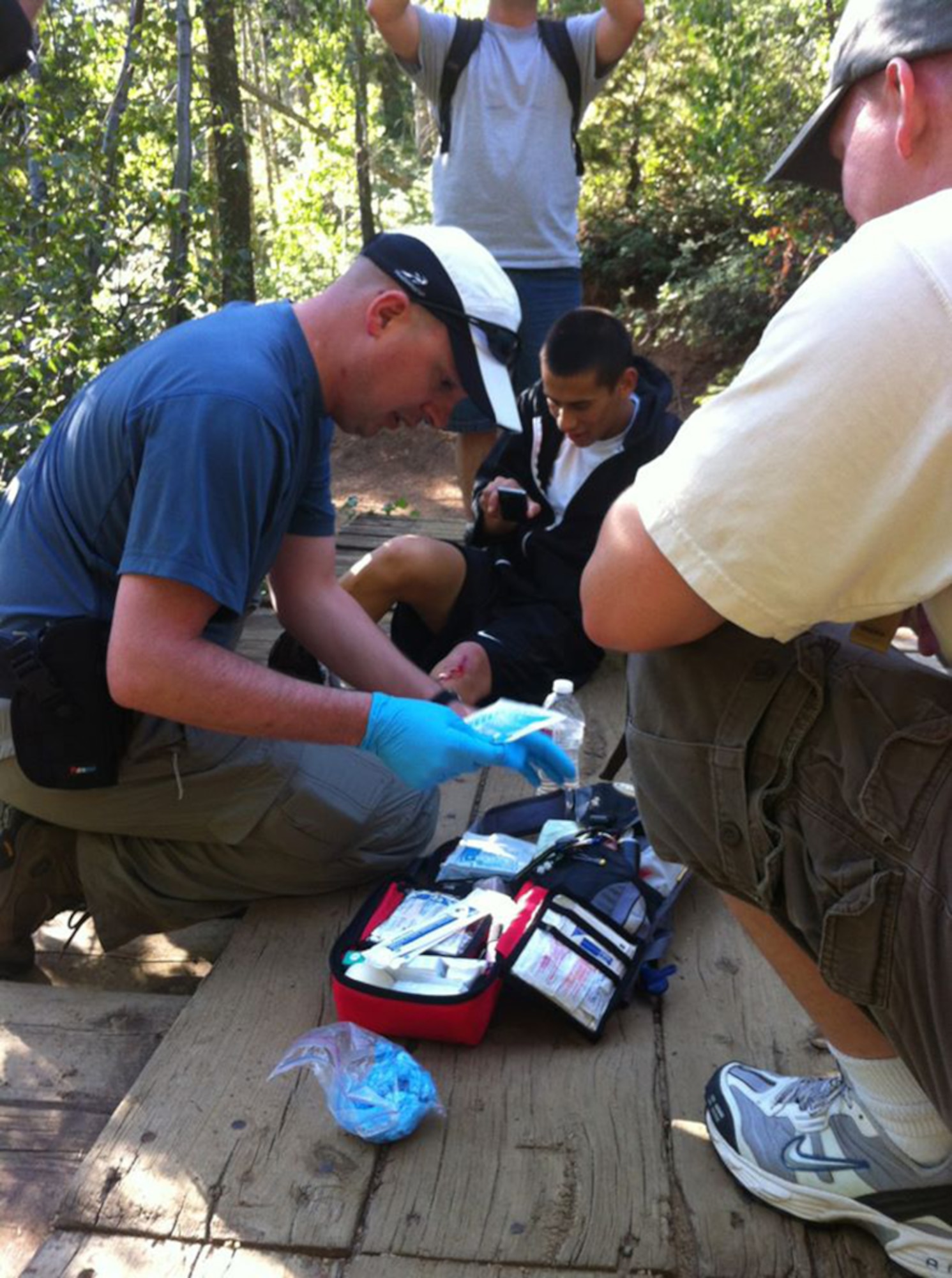 Taking advantage of his search and rescue training, Air Force Reserve Tech. Sgt. David Hodge tends to a fellow 6th Space Operations Squadron member during a squadron hike in Colorado Spring's Helen Hunt Falls area. Hodge, 6th Space Operations Squadron Non-Commissioned Officer in Charge of standardization and evaluation, uses his amateur radio skills to support emergency responders during times of emergencies. 