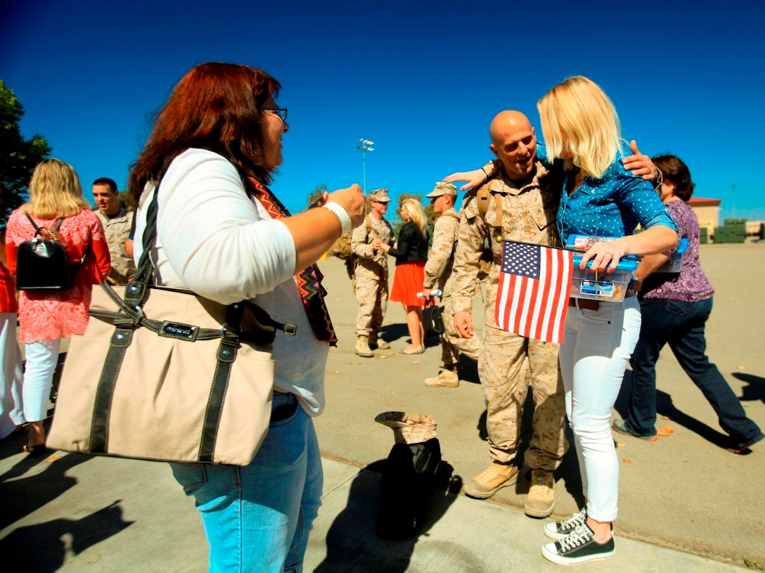 Marissa Cordova, wife of 1st Lt. Charlie Cordova, hugs her husband for the first time in 10 months during a homecoming celebration aboard Camp Pendleton, Calif., Oct. 18. The newlyweds only spent six days together before Cordova's 10-month deployment to Afghanistan.