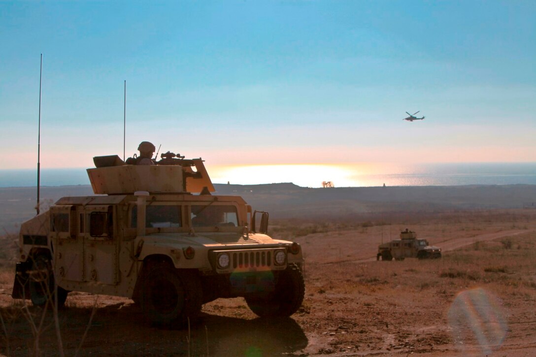 Marines with 1st Air Naval Gunfire Liaison Company in a convoy of five Humvees communicate with two pilots to locate a downed pilot during a tactical rescue of aircraft and personnel exercise aboard Camp Pendleton, Calif., Oct. 21.