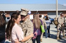 A Marine with 2nd Explosives Ordnance Disposal Company, 8th Engineer Support Battalion, 2nd Marine Logistics Group reunites with a loved one during a homecoming event for 2nd EOD Co. aboard Camp Lejeune, N.C., Oct. 26, 2013. Service members with the company returned to family and friends after a successful seven-month tour in Afghanistan.