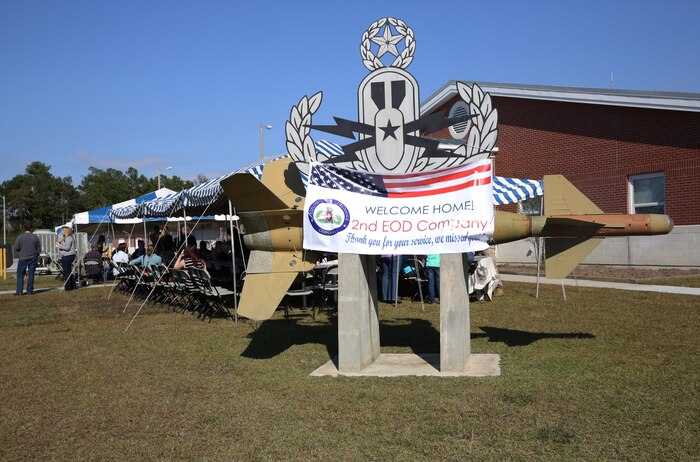 A welcome home banner hangs on the 2nd Explosives Ordnance Disposal Company, 8th Engineer Support Battalion, 2nd Marine Logistics Group emblem during a homecoming event for 2nd EOD Co. aboard Camp Lejeune, N.C., Oct. 26, 2013. The company returned to Camp Lejeune following a seven-month deployment of Afghanistan.