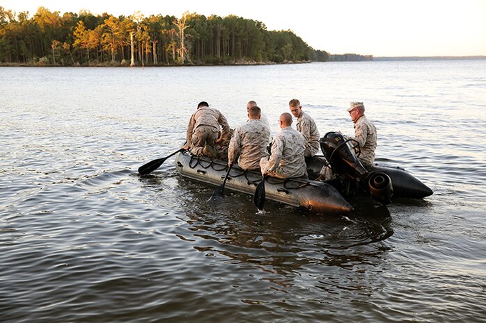 Six Marines with Improved Ribbon Bridge Platoon, 8th Engineer Support Battalion, 2nd Marine Logistics Group cross French Creek using zodiac boats during a field exercise aboard Camp Lejeune, N.C., Oct. 24, 2013. Marines ran approximately 2.5 miles with weighted packs before reaching the zodiacs. 
