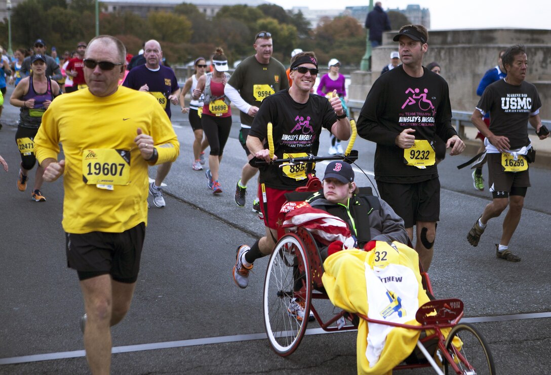 A participant in the 38th Marine Corps Marathon gives a thumbs up while passing spectators in Washinton Oct. 27, 2013. The MCM is currently the fifth largest marathon in the United States and the ninth largest in the world. The People's Marathon is composed of runners from all over the U.S. and more than 50 countries. (U. S. Marine Corps photo by Lance Cpl. Dylan Bowyer/Released)