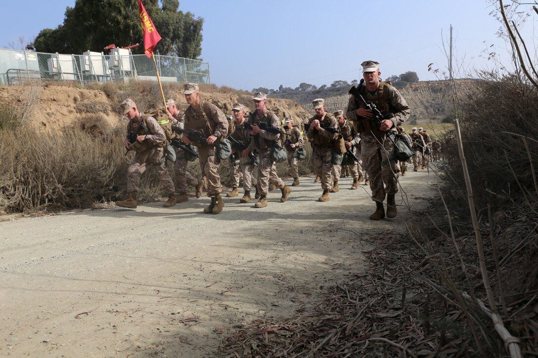 Marines with the 11th Marine Expeditionary Unit conduct a hike here Oct. 25. For most of the hike, the Marines wore Mission Oriented Protective Posture, or MOPP, gear. The Marines wore the gear because during the hike, they were exposed to CS gas as part of their annual CBRND training. (Photo by Lance Cpl. Demetrius Morgan/RELEASED)