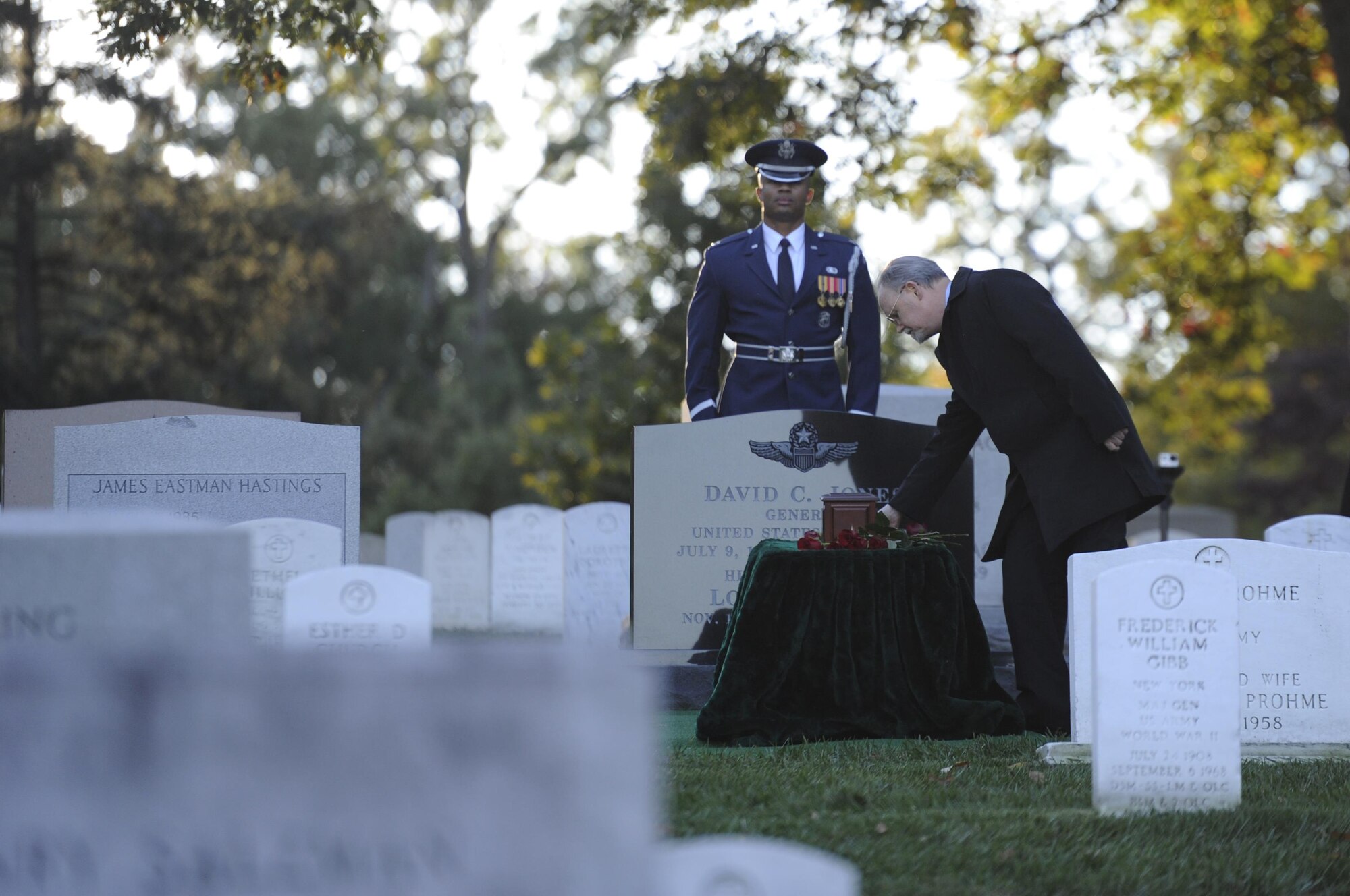 An attendee places a rose over retired Gen. David C. Jones burial site after his funeral Oct. 25, 2013, at Arlington National Cemetery, Va. Jones served four years as Air Force chief of staff from 1974 to 1978 until he was appointed as chairman of the Joint Chiefs of Staff. As chairman he served as the senior military adviser to the president, helping set in motion a sweeping reorganization of the nation’s military command. Jones died Aug. 10, 2013 at the age of 92. 