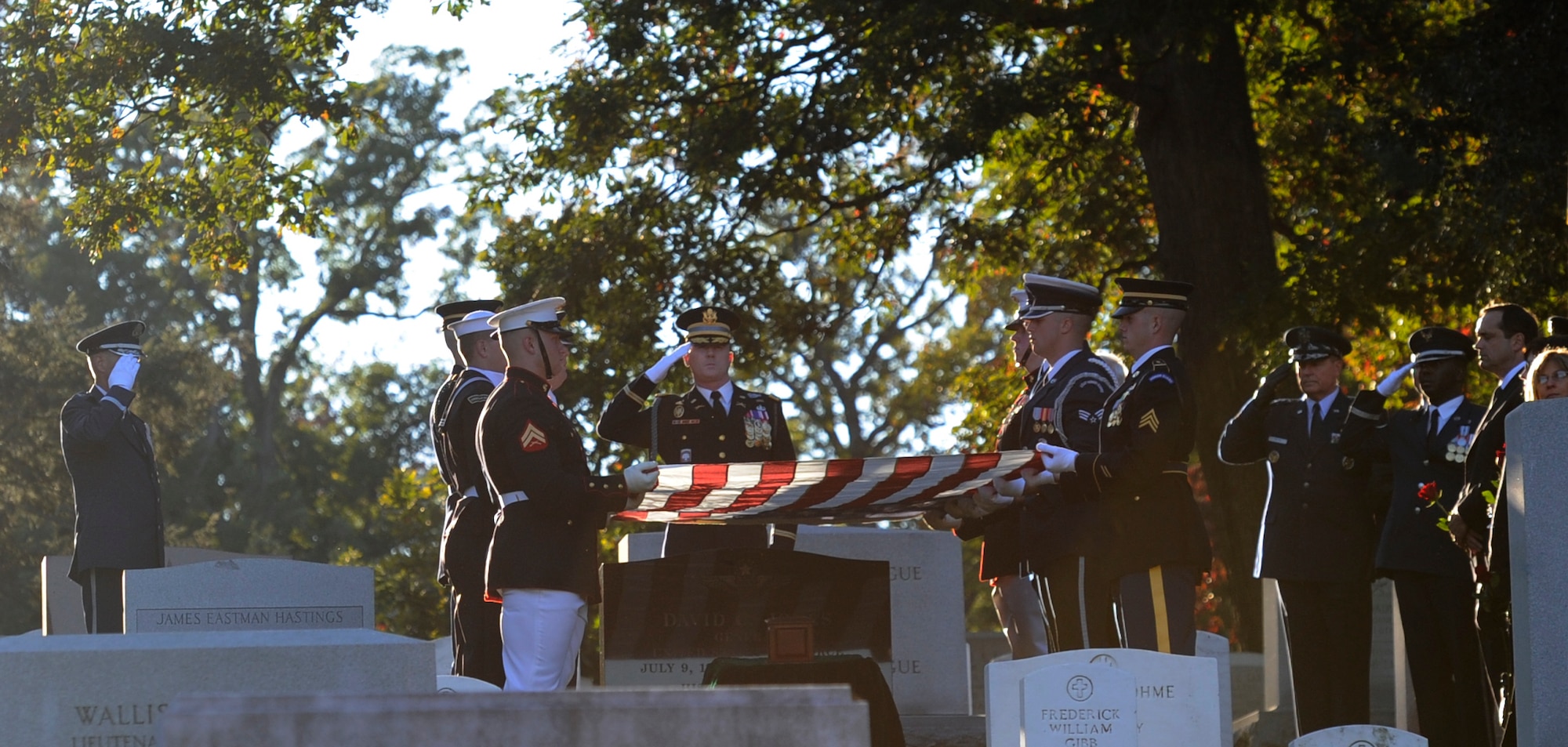 A joint service color guard folds the flag over retired Gen. David C. Jones’ casket during his funeral Oct. 25, 2013, at Arlington National Cemetery, Va. Jones served four years as Air Force chief of staff from 1974 to 1978 until he was appointed chairman of the Joint Chiefs of Staff June 21, 1978. As chairman he served as the senior military adviser to the president, the National Security Council and the secretary of Defense. He entered the Army Air Corps and began aviation cadet training in April 1942. He received his commission and pilot wings in February 1943. The Army, Marine Corp and Coast Guard were also in attendance conducting military honors.