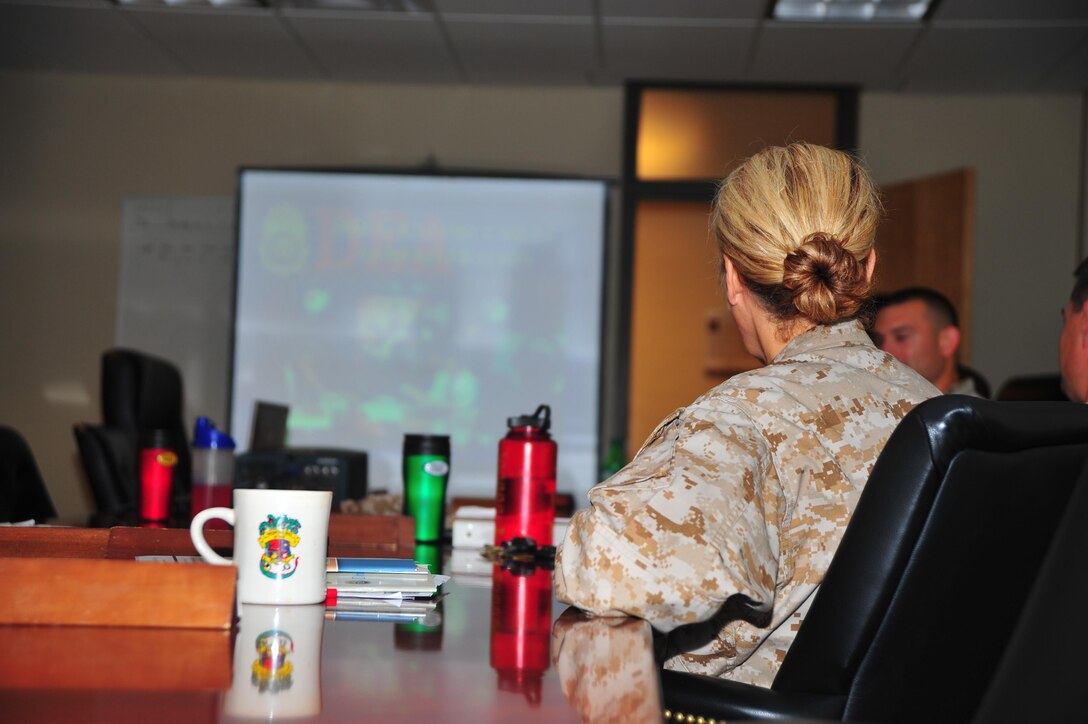 Col. Robin Gallant, commanding officer of Headquarters and Service Battalion,  attends a meeting about drug abuse and how to recognize the signs of a drug abuser in accordance with Red Ribbon Week at Yale Hall on Oct. 23, 2013. The brief was given by DEA Agent Steve Peterson, who talked about the importance of recognizing and helping drug abusers. 