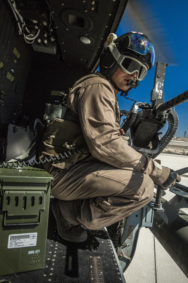 Lance Cpl. Chris Eichelberger, a gunner with a Marine Light Attack Helicopter Squadron (HMLA) 169, and a native of San Diego, Calif., looks out of the UH-1Y Huey helicopter in preparation to launch from the flight line at Marine Corps Air Station Yuma, Ariz., as part of Weapons and Tactics Instructors Course 1-14. WTI is a biannual, seven-week training evolution that trains pilots from every corner of Marine aviation to become experts in tactics and effective situational employment of their aircraft and weapons systems. The intent is to make those who complete the course fully capable of passing their knowledge on to newer pilots. (Official photo by Cpl. Zachary Scanlon)