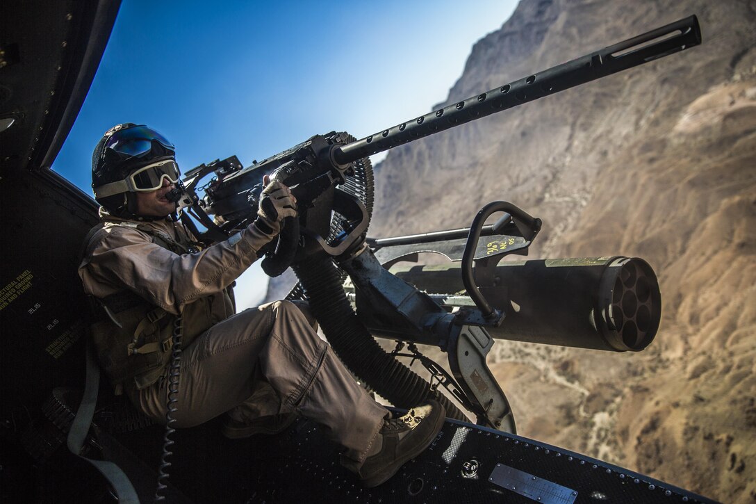 Lance Cpl. Chris Eichelberger, a gunner with a Marine Light Attack Helicopter Squadron (HMLA) 169, and a native of San Diego, Calif., fires on a target at the Chocolate Mountain Aerial Gunnery Range, Calif., as part as part of Weapons and Tactics Instructors Course 1-14. WTI is a biannual, seven-week training evolution that trains pilots from every corner of Marine aviation to become experts in tactics and effective situational employment of their aircraft and weapons systems. The intent is to make those who complete the course fully capable of passing their knowledge on to newer pilots. (Official photo by Cpl. Zachary Scanlon)