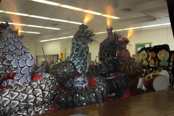 Actors in dragon costume light fireworks to add a fire-breathing effect during a kagura performance at the Japanese American Society Culture Festival held at Matthew C. Perry’s high school cafeteria here, March 9, 2013. The show called Yamatano-Orochi, is based on a Japanese folklore of an eight-headed and eight-tailed serpent.