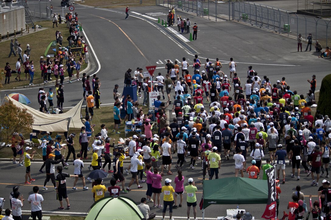 Participants in the 46th annual Kintai Marathon begin the full marathon portion of the race, which started in front of the IronWorks Gym here, April 14, 2013. More than 1000 people participated in the marathon.