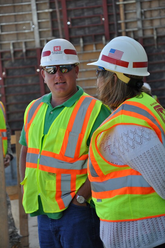 DEVILS LAKE, N.D. -- Mathew Andersen, left, engineering and construction, and Bonnie Greenleaf, project management,discuss the Devils Lake, N.D., project July 31.