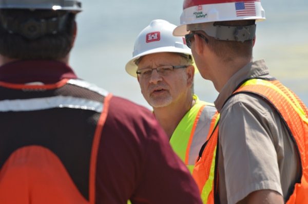 LANSING, Iowa -- Tom Novak, project management, talks with federal and state partners on a recently built island within the Mississippi River near Lansing, Iowa, Aug. 23.