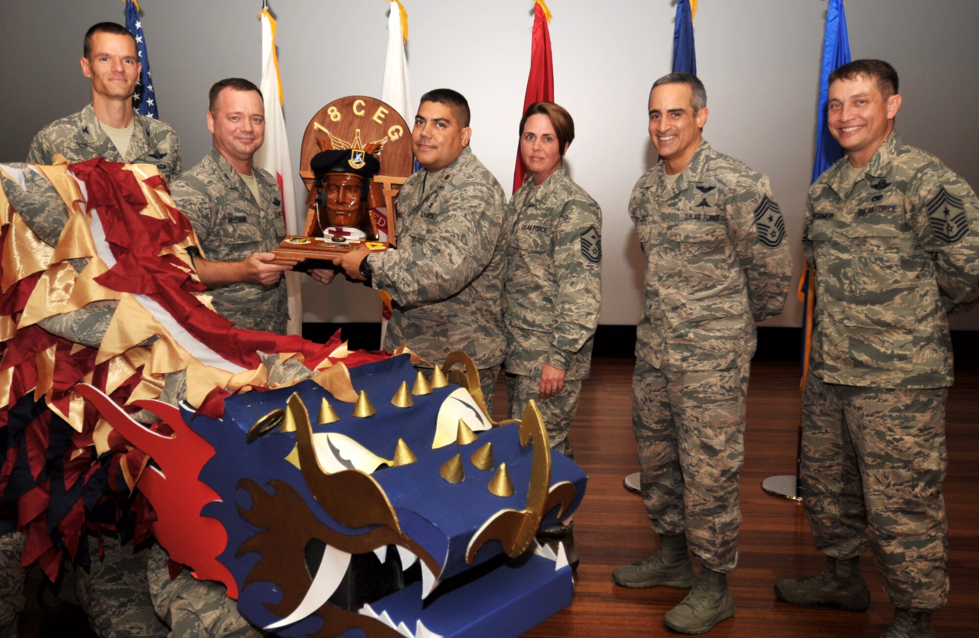 U.S. Air Force Col. Brian McDaniel, 18th Wing vice commander, presents the spirit award to Maj. Robert Kongaika, 18th Component Maintenance Squadron commander, during Team Kadena’s Third Quarterly Awards ceremony on Kadena Air Base, Japan, Oct. 25, 2013. This award is given to the Team Kadena unit that showed the most “spirit” during the ceremony. (U.S. Air Force photo by Naoto Anazawa)