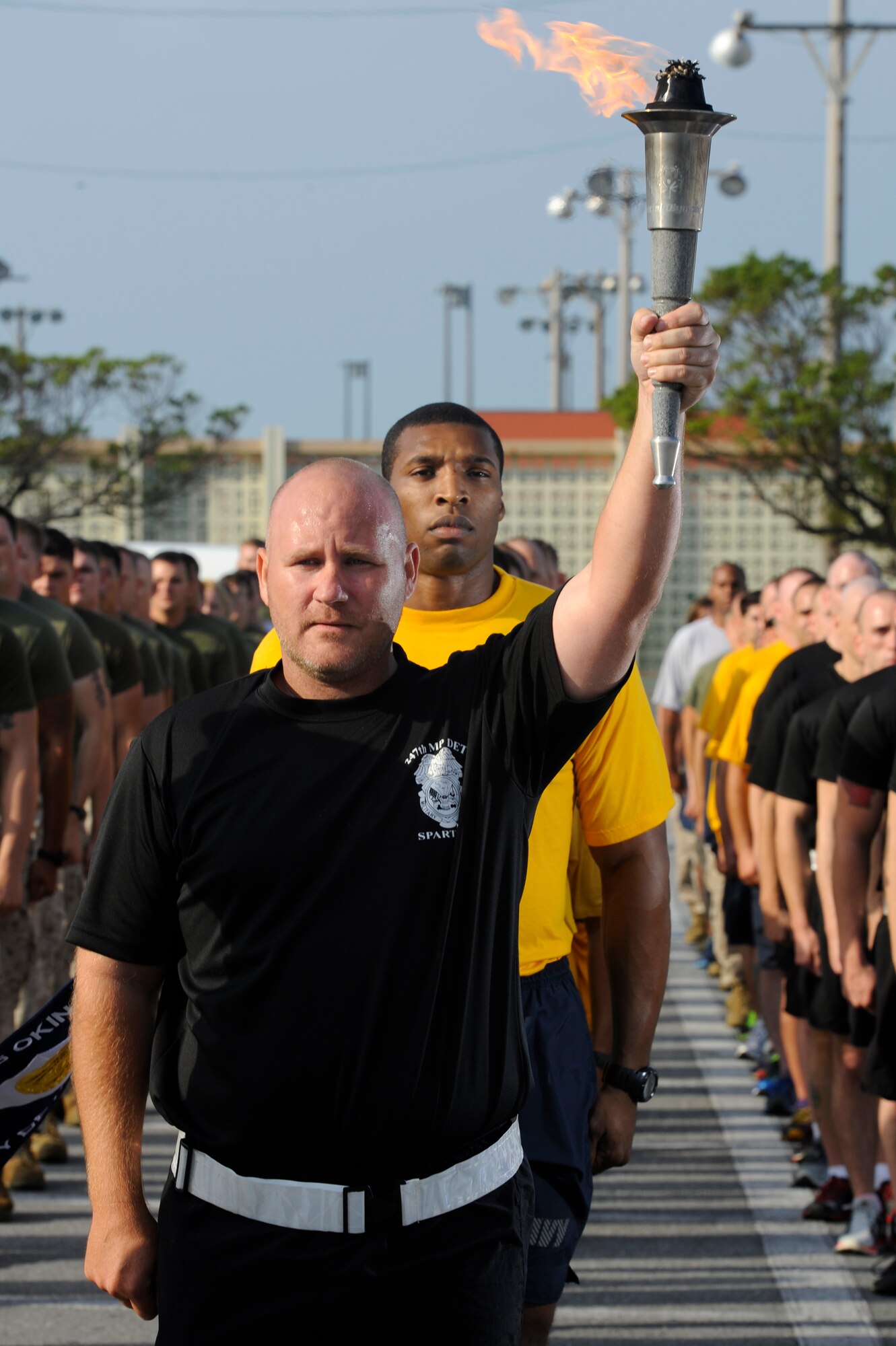 More than 70 U.S. military members stand in formation during the opening ceremony of the Kadena Special Olympics torch run at Kadena Air Base, Japan, Oct. 26, 2013. The 14th annual Kadena Special Olympics is scheduled for Nov. 2, 2013. (U.S. Air Force photo by Senior Airman Marcus Morris) 