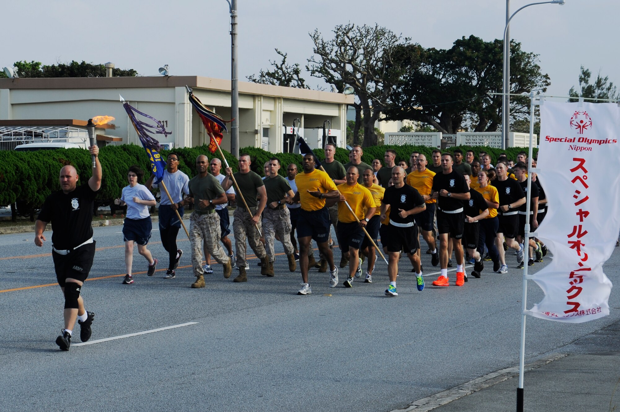 U.S. military joint forces run together for the Kadena Special Olympics torch run at Kadena Air Base, Japan, Oct. 26, 2013. This year marks the 14th annual Kadena Special Olympics. (U.S. Air Force photo by Senior Airman Marcus Morris) 
