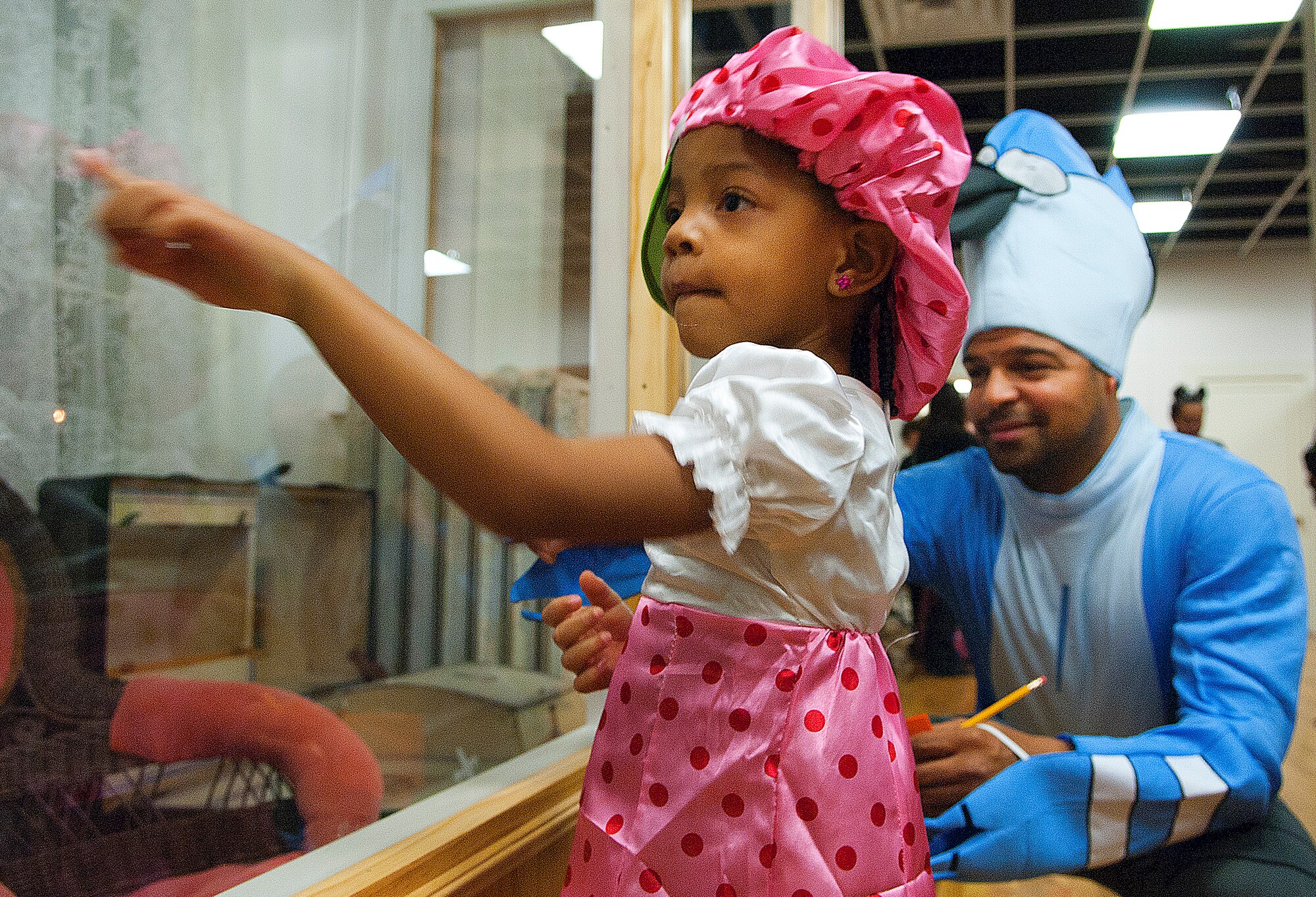 131025-F-CP692-002
Tech. Sgt. Marheshi Tucker, 90th Security Forces Groups, helps his daughter, Taylor, 4, look for ghosts in the display cases at the museum Oct. 25. This is the first year the museum staff and volunteers organized this event to include a pumpkin carving contest, scavenger hunt, costume contest, trivia, and old "scary" movies and popcorn.  (Photo by 1st Lt. Eydie Sakura)
