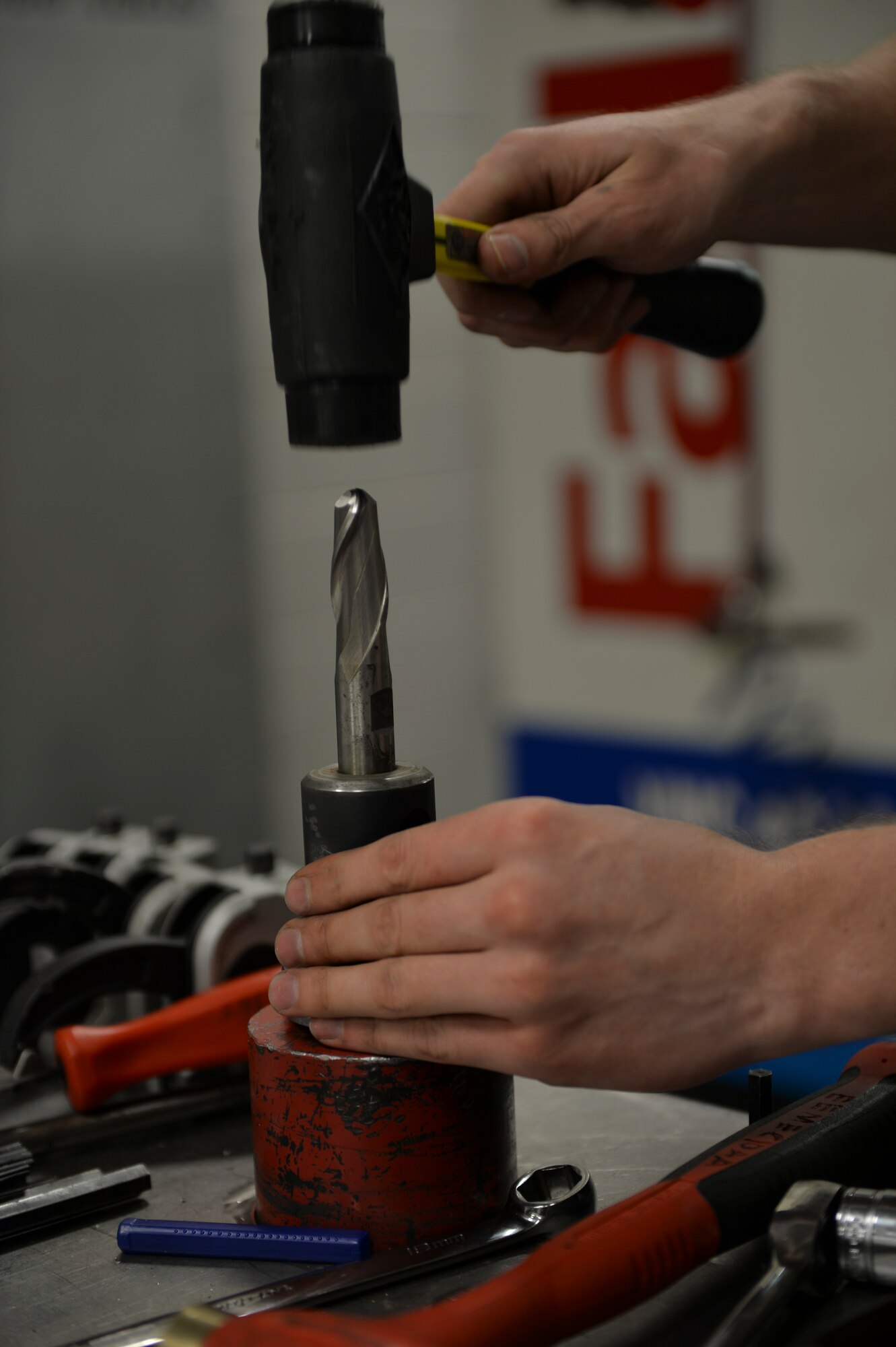Staff Sgt. James All, 1st Special Operations Equipment Maintenance Squadron aircraft metals technology craftsman, installs a cutting tool in the metals technology shop at Hurlburt Field, Fla. Oct. 24, 2013. The cutting tool is part of a vertical machining center, which uses a liquid cooled cutting tool to create custom parts.( U.S. Air Force Photo/ Staff Sgt. John Bainter)