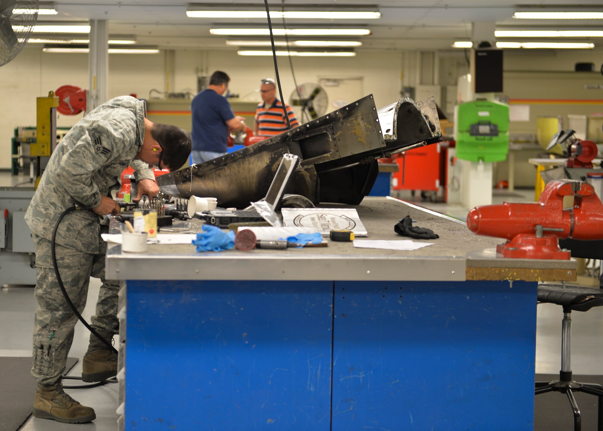 Senior Airman Sergio Gonzalez, 1st Special Operations Equipment Maintenance Squadron aircraft structural maintenance technician, grinds a component of a C-130 aft nacelle at Hurlburt Field, Fla., Oct. 24, 2013. The aircraft nacelle is housing which holds engines, fuel, or equipment on an aircraft. (U.S. Air Force Photo/ Staff Sgt. John Bainter)