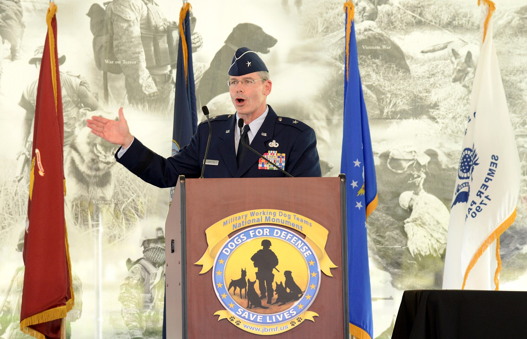 Brig. Gen. Bob Labrutta, commander 502nd Air Base Wing and Joint Base SAn Antonio, addresses the attendees at the U.S. Military Working Dog Teams National Monument unveiling Oct. 28, at Joint Base San Antonio-Lackland. JBSA-Lackland is the home to the Department of Defense Military Working Dog Program and is where the U.S. Armed Forces has been training its military working dog teams since 1958. It is the world's largest training center for military dogs and handlers and is also home to the largest veterinary hospital for military working dogs. (U.S. Air Force photo by Benjamin Faske) (released)