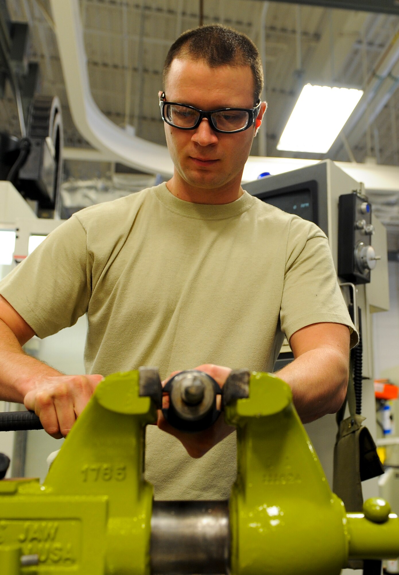 Staff Sgt. James All, 1st Special Operations Equipment Maintenance Squadron aircraft metals technology craftsman, removes a cutting tool from a spindle prior to machining at Hurlburt Field, Fla., Oct. 24, 2013. The vertical machining center uses a process of using rotary cutters to remove material from a work piece. (U.S. Air Force photo/Airman 1st Class Jeff Parkinson)